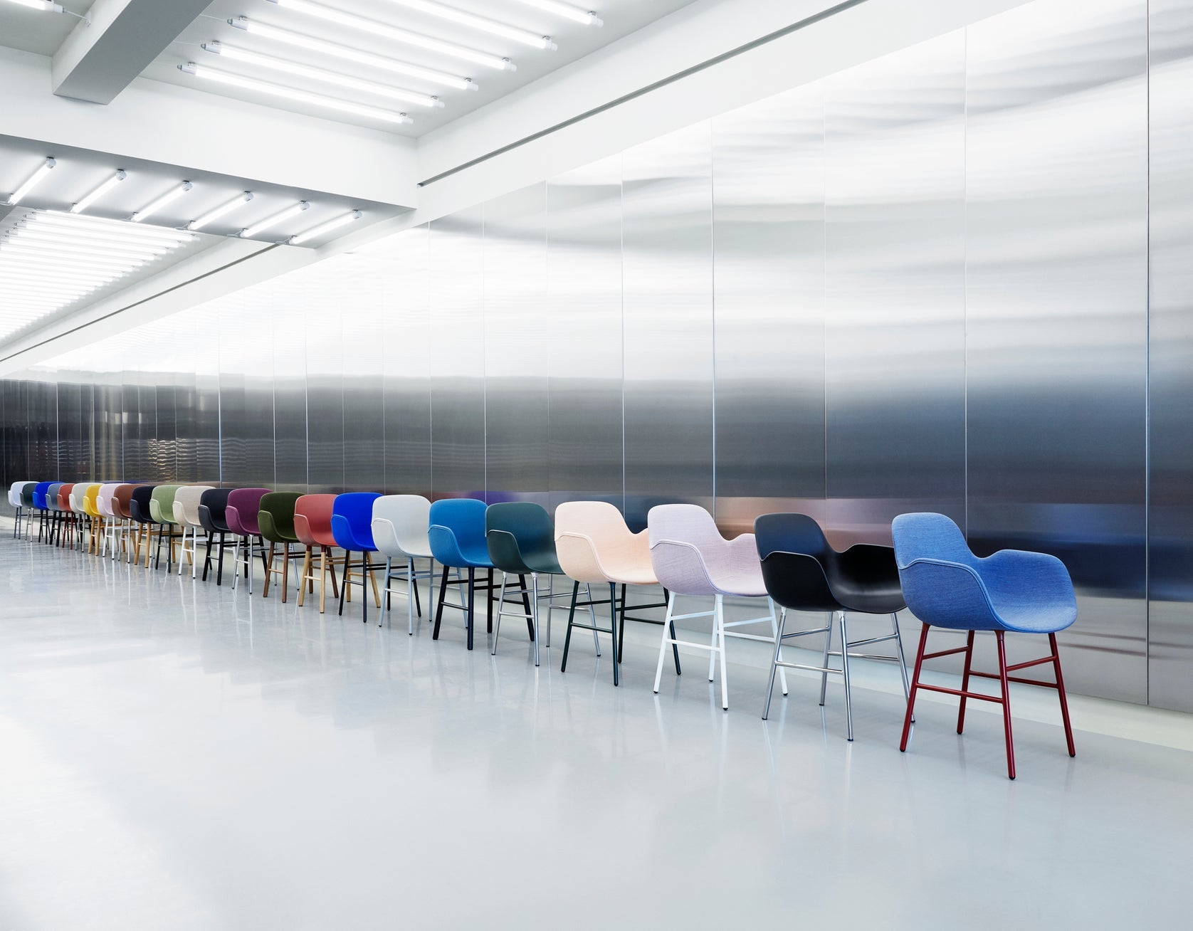 Chair with armrests blue forms with a chrome base