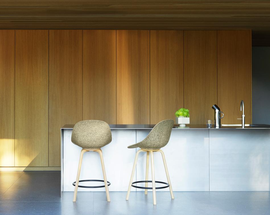Bar chair with backwards upholstered green mats with beech plywood
