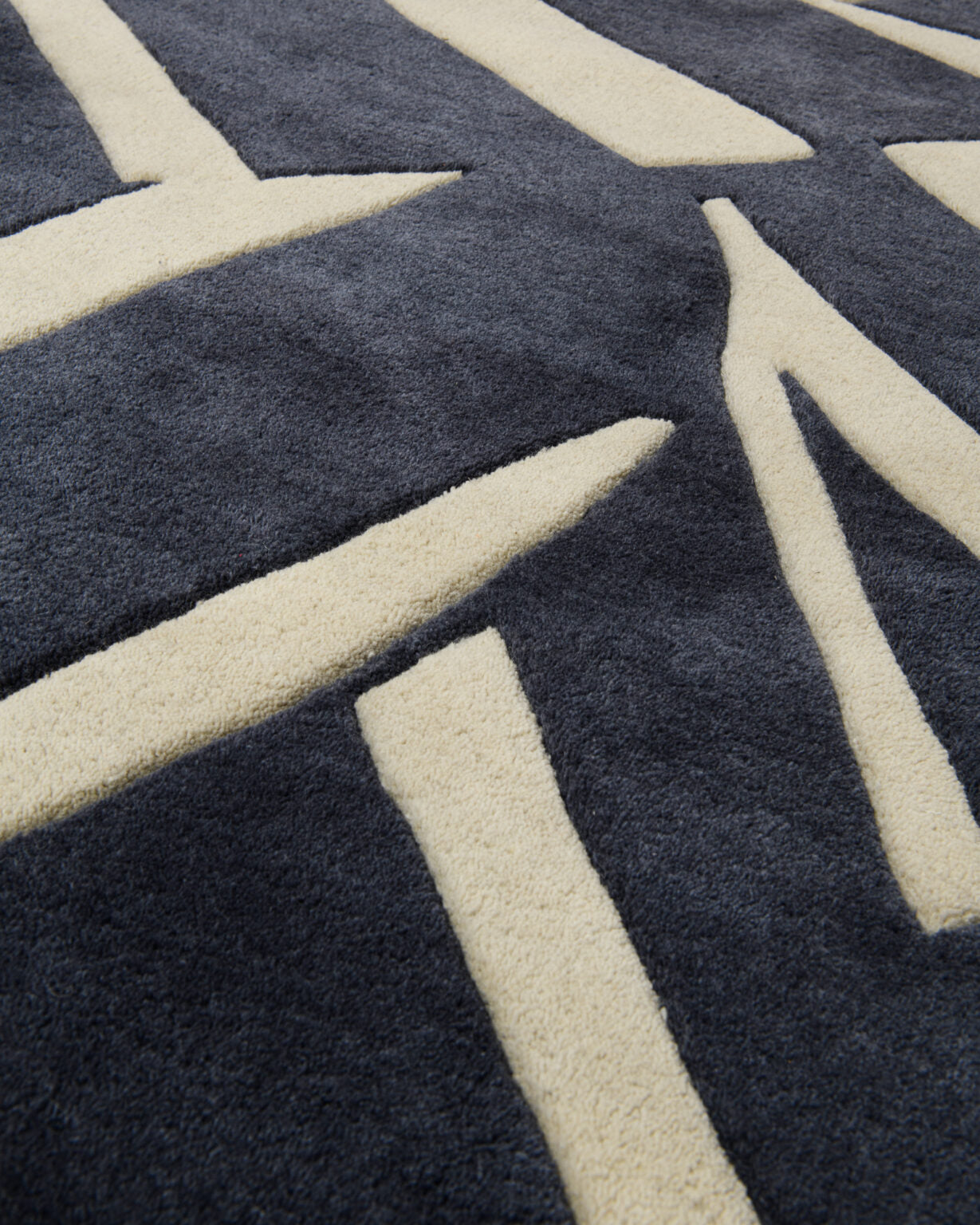 Asymmetrical decorative rug INTO THE FOLD black with beige