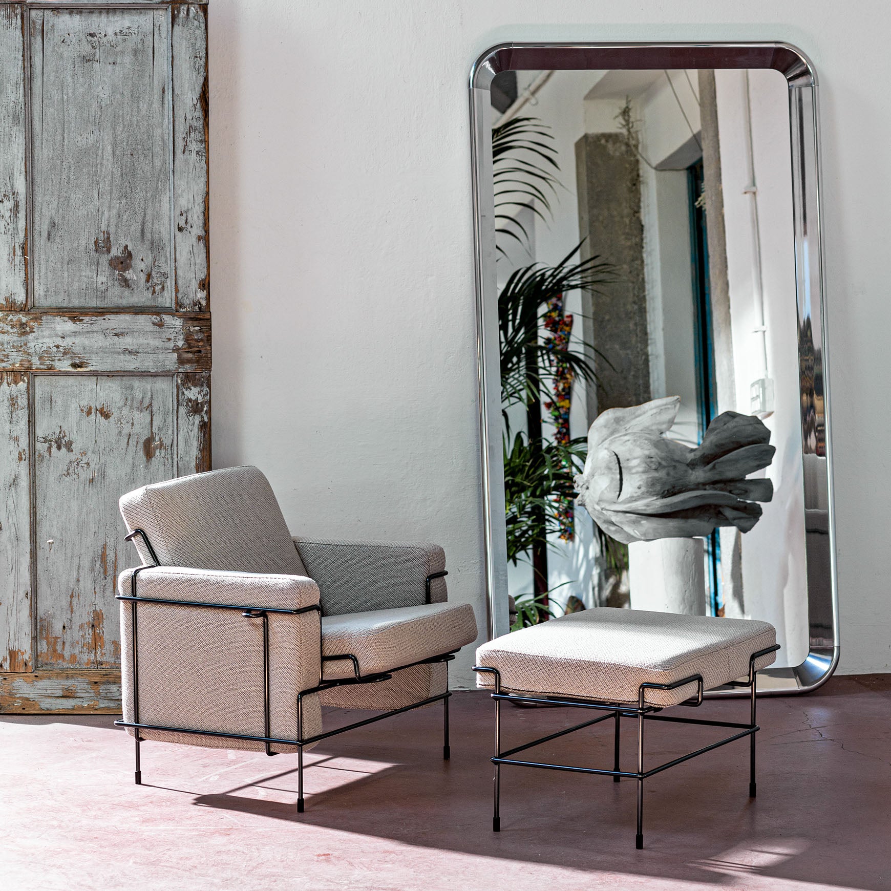 TRAFFIC upholstered armchair with a black steel base