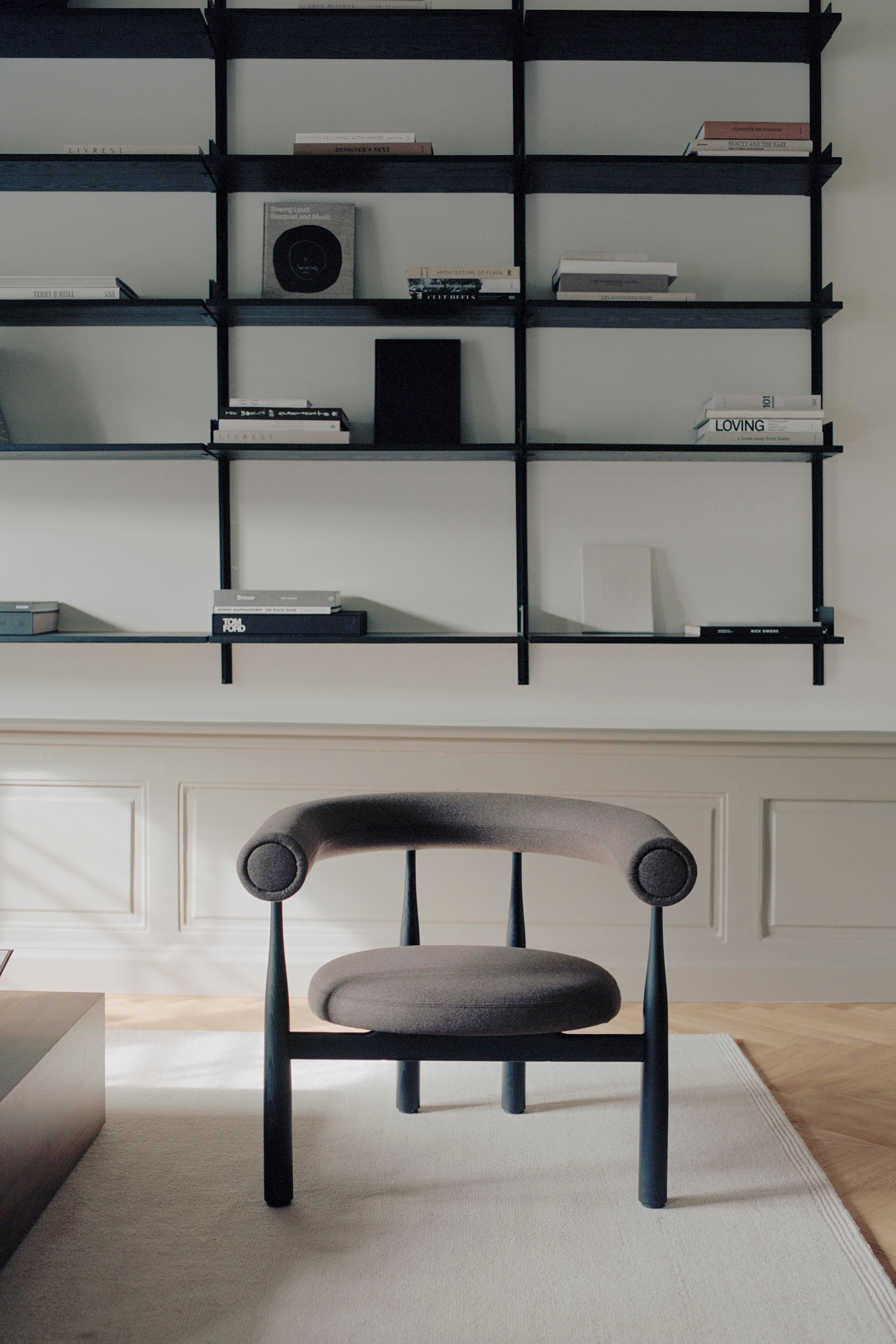 BUKOWSKI upholstered armchair with a black beech base