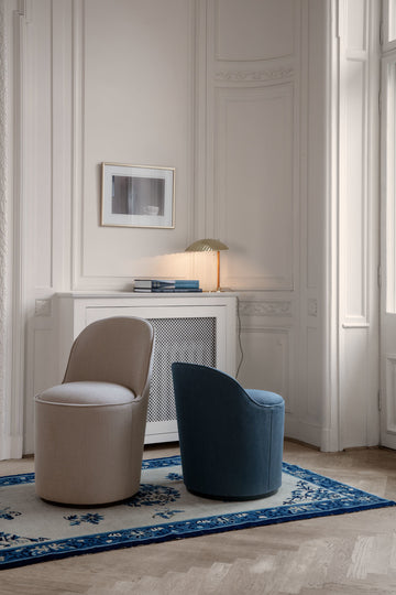 Upholstered pouf with a brass base