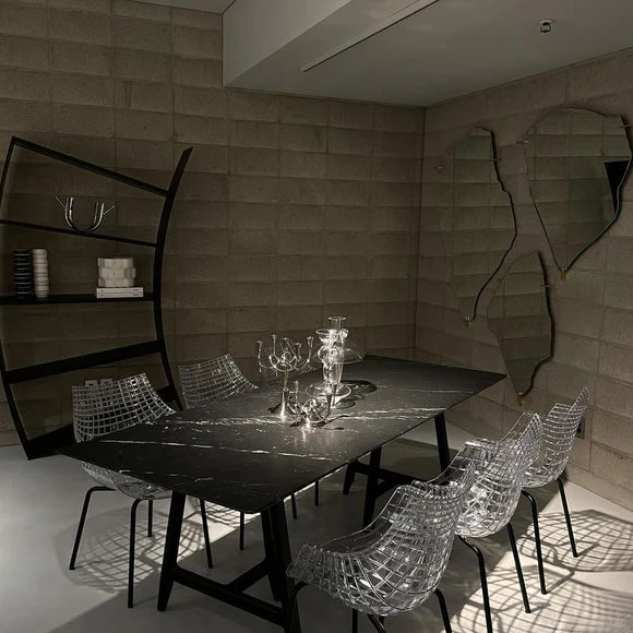 A transparent meridiana chair with a black base