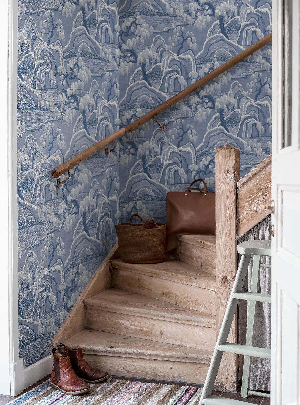 Non-woven paper wallpaper with INDIGO GARDEN landscape in blue and beige