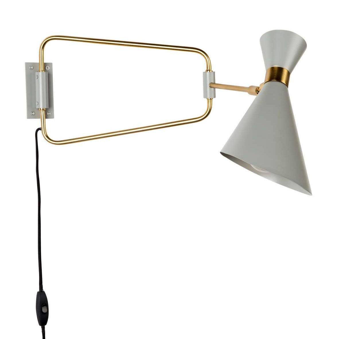 Shady's wall lamp is something timeless, which will always be on time and fashion. The asymmetrical lampshade accosted on straight metal shoulders was completed with brass details. Thanks to its elegance, it fits perfectly into a modern living room and hallway, giving a pleasant light falling on the wall or on a favorite picture.