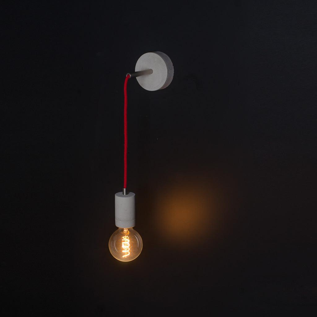 Wall lamp Kall Wall is a decoration created for loft interiors. Made of concrete frame, headliner and polyester black braided cable. Available in different colors of concrete. Manual performance causes that each copy is unique and there may be delicate differences in color and texture.